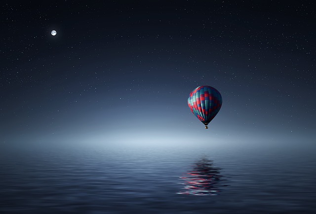 Hot air balloon reflected in ocean