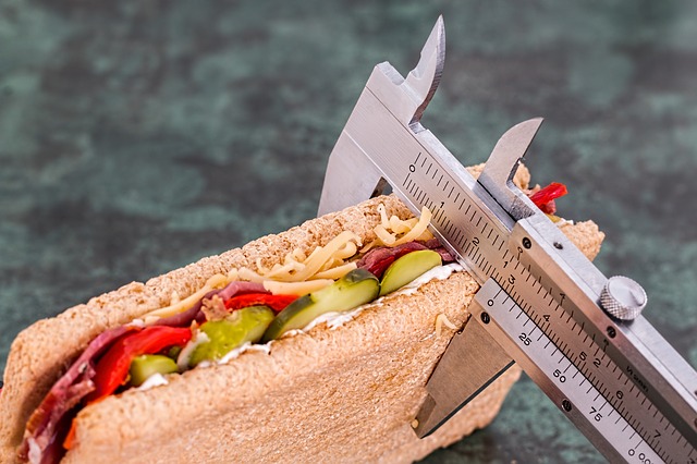 Calipers measuring thickness of a sandwich