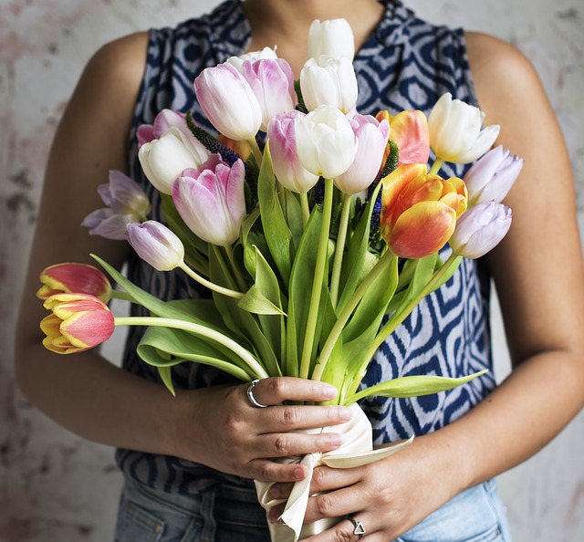 Someone carrying a bunch of tulips