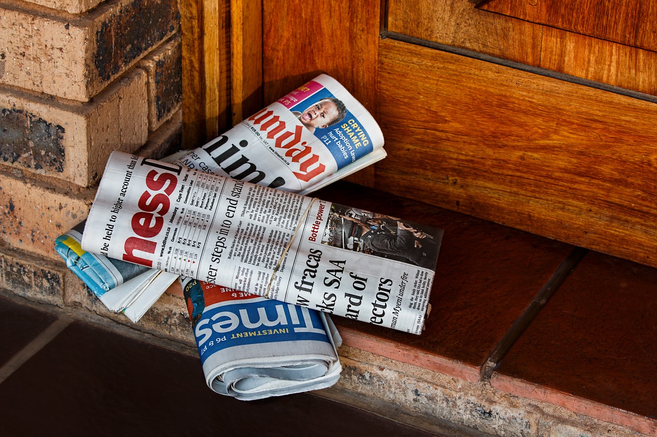 Folded newspapers on doorstep