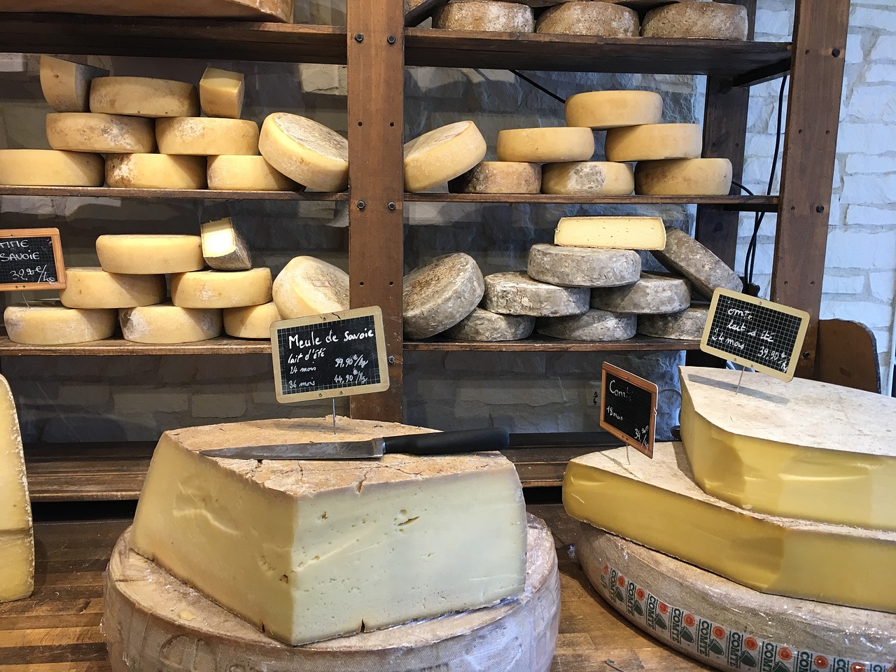 Whole cheeses in shop