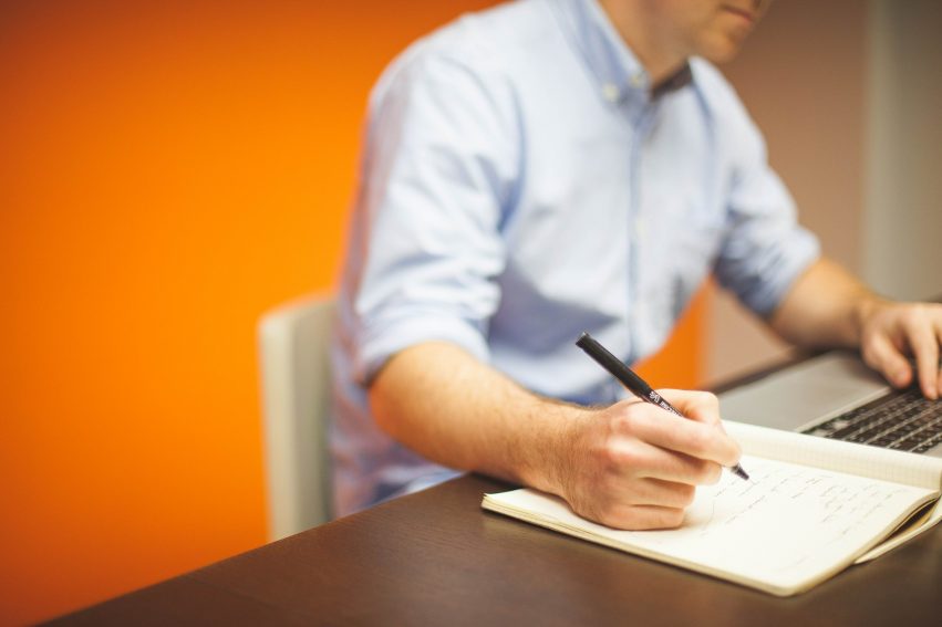 Man with laptop and notebook