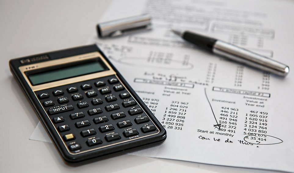 Calculator, pen and paper figures