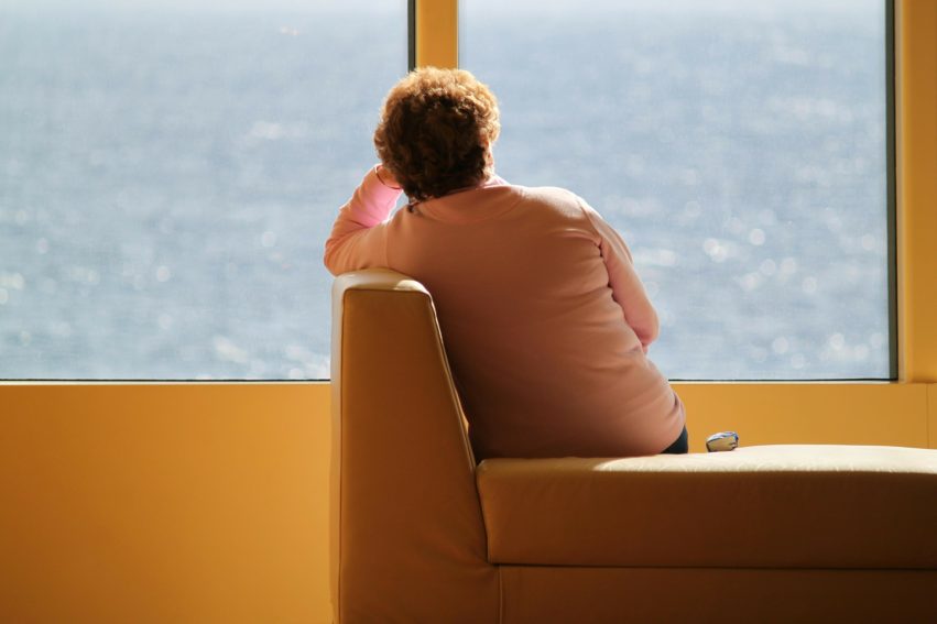 woman on sofa, facing window